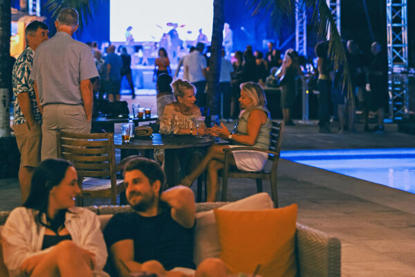 People having drinks at a bar in Turks and Caicos, dusk. 