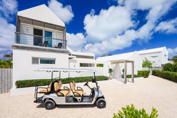 A six-seater beach cart in front of a luxurious villa in Turks and Caicos. 