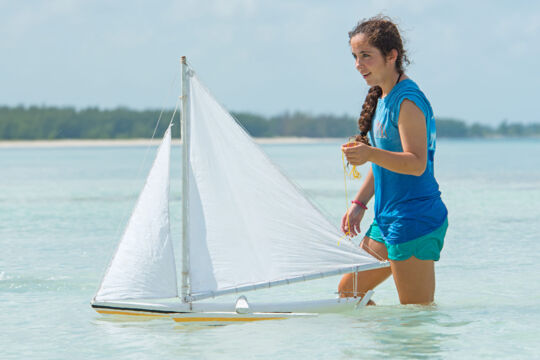 Racing a model sailboat on Bambarra Beach, Middle Caicos.