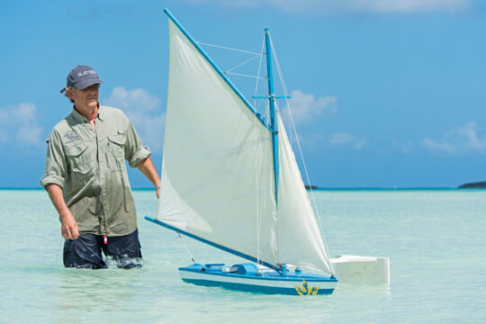 Steering a model sailboat on Bambarra Beach, Middle Caicos.