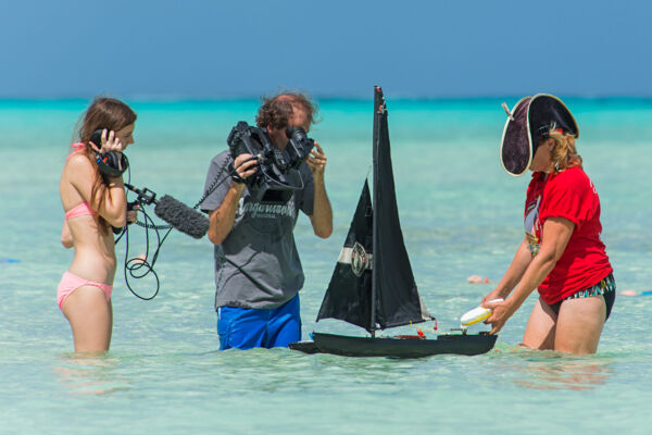 News cameras filming a model sailboat on Bambarra Beach, Middle Caicos.