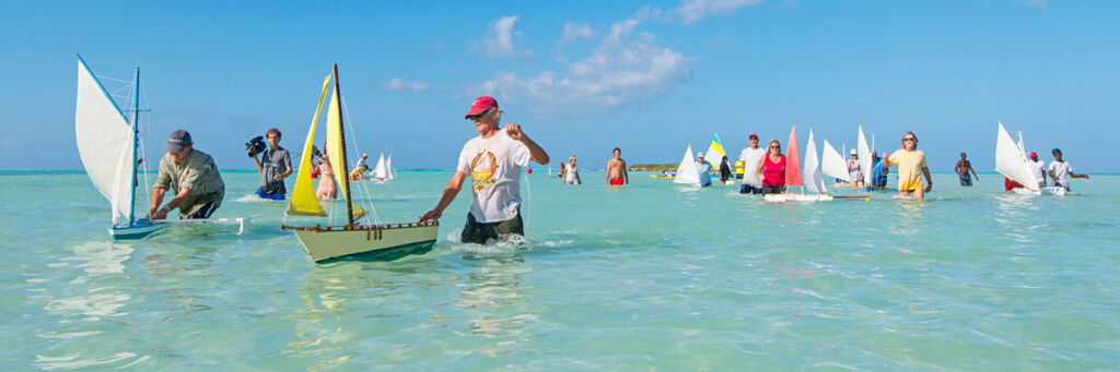 People racing models sailboats on Bambarra Beach.