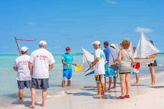 Model sailboat racers preparing to launch their boats, Bambarra beach.