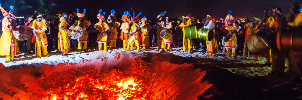 Junkanoo band performing near a bonfire on Grace Bay Beach.